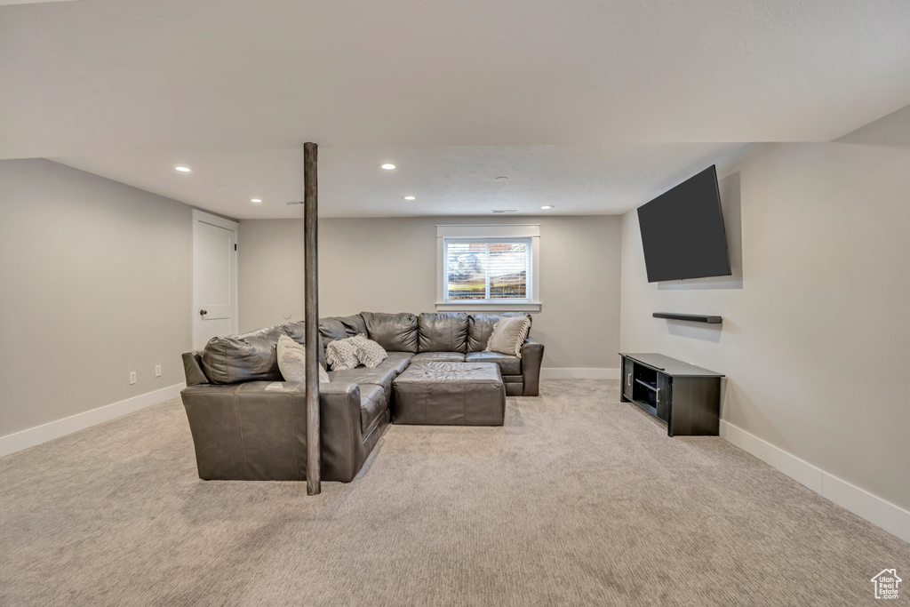 Living room with light carpet, recessed lighting, and baseboards