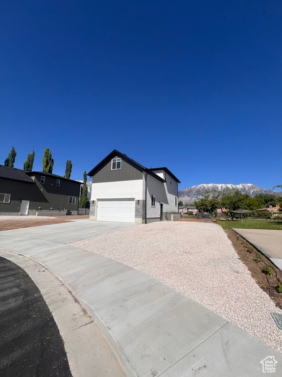 View of home\'s exterior with a mountain view, driveway, and an attached garage