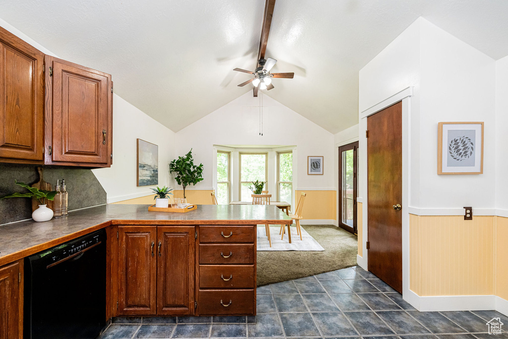 Kitchen with black dishwasher, a peninsula, ceiling fan, a wainscoted wall, and dark countertops