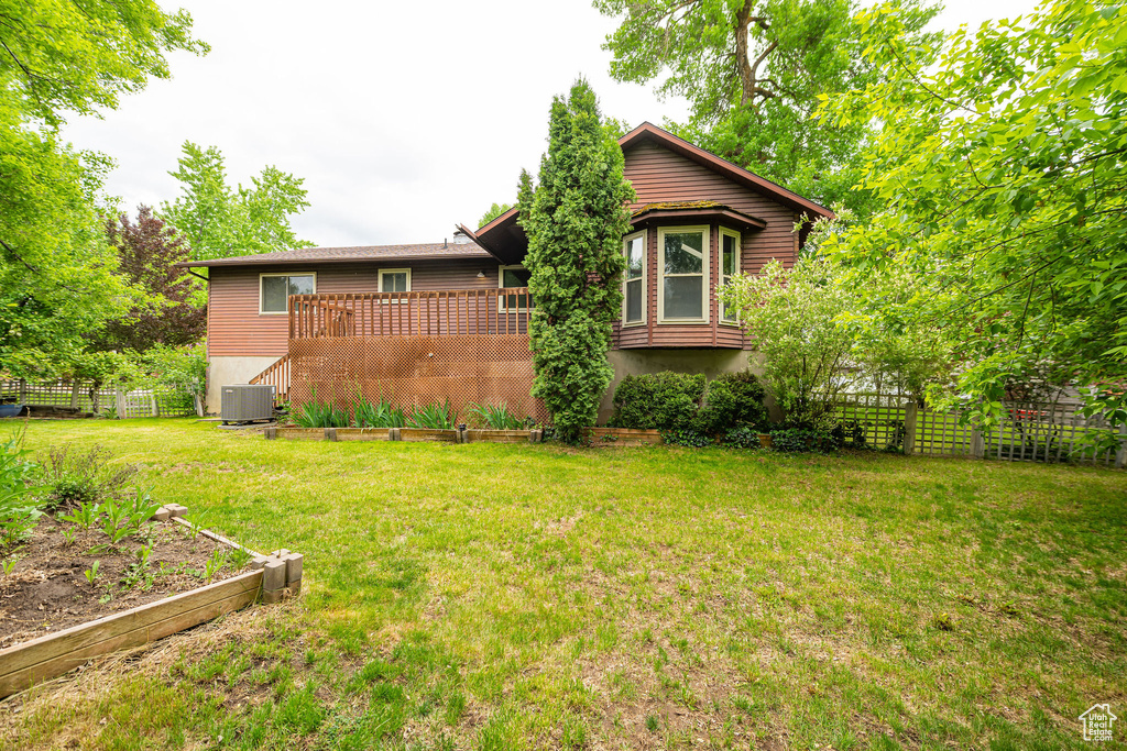 View of front of property with central AC and a deck