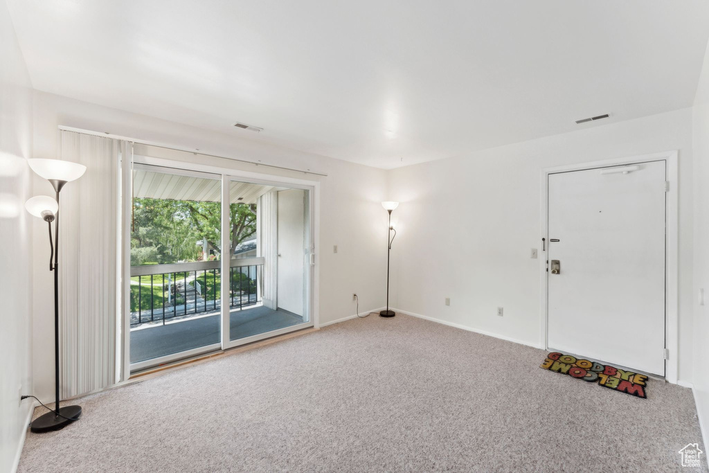 Empty room with carpet flooring and baseboards