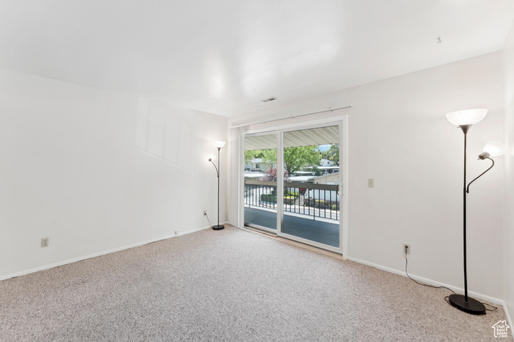 Empty room featuring carpet floors and baseboards