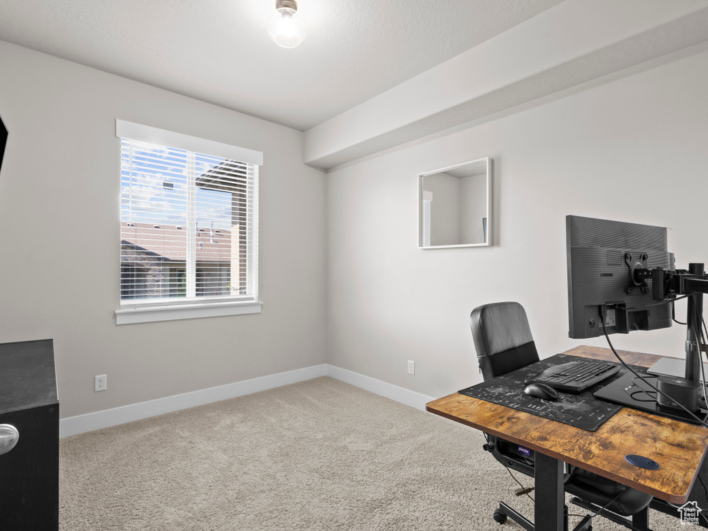 Office area featuring carpet and baseboards