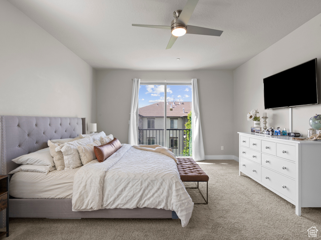 Bedroom featuring light carpet, ceiling fan, and baseboards