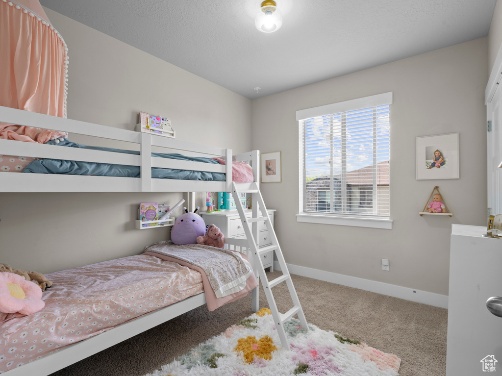 Bedroom with carpet floors and baseboards