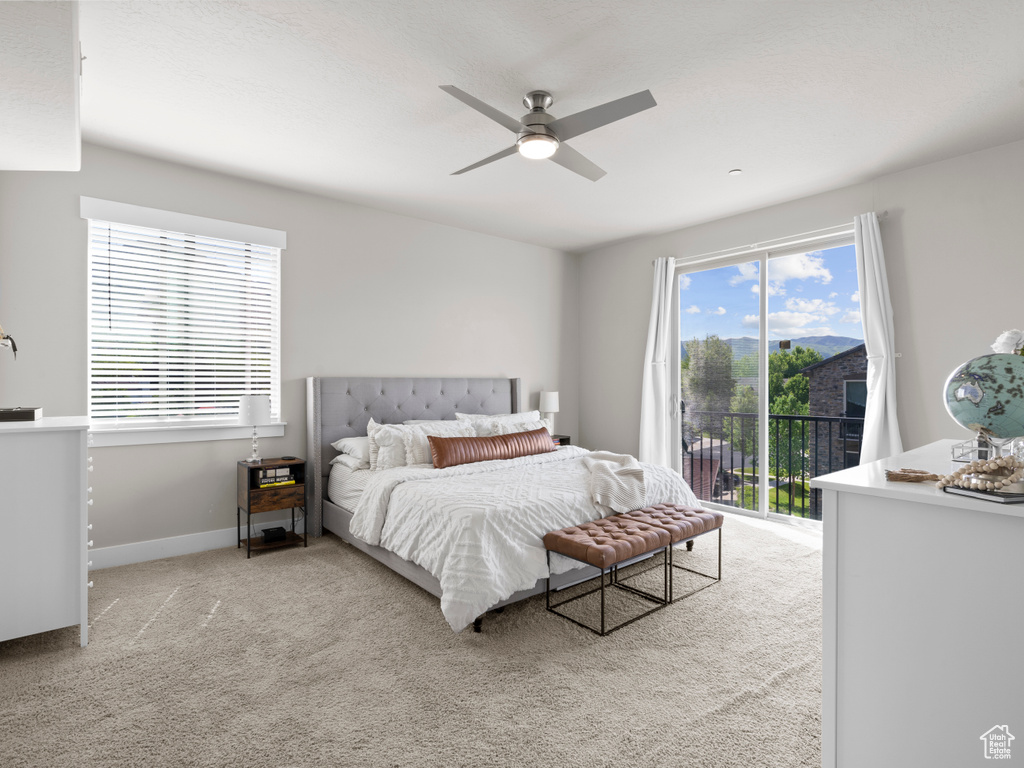 Bedroom with access to outside, carpet flooring, a ceiling fan, and baseboards