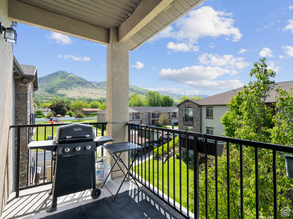 Balcony with area for grilling, a mountain view, and a residential view