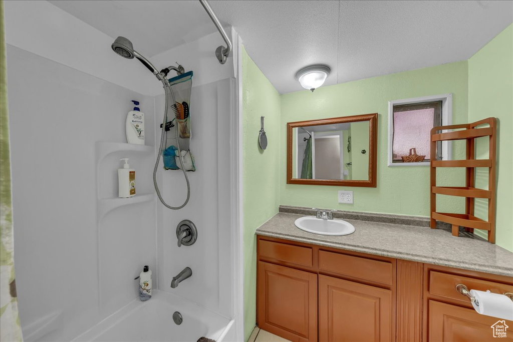 Bathroom featuring  shower combination and vanity