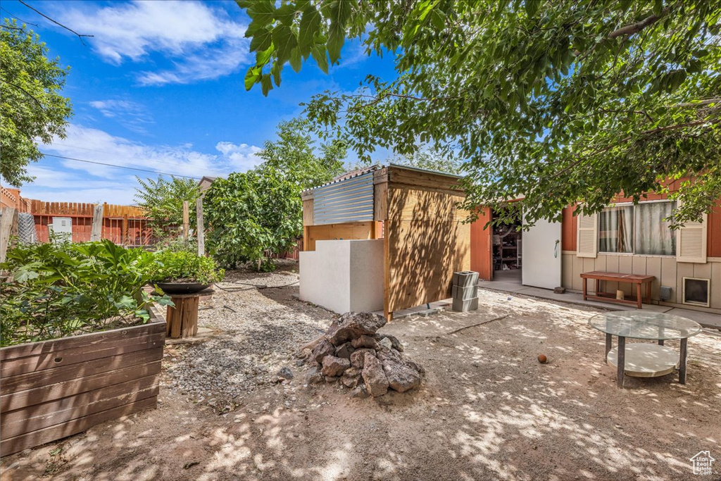 View of patio / terrace featuring an outbuilding and fence