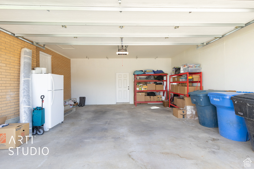 Garage featuring freestanding refrigerator