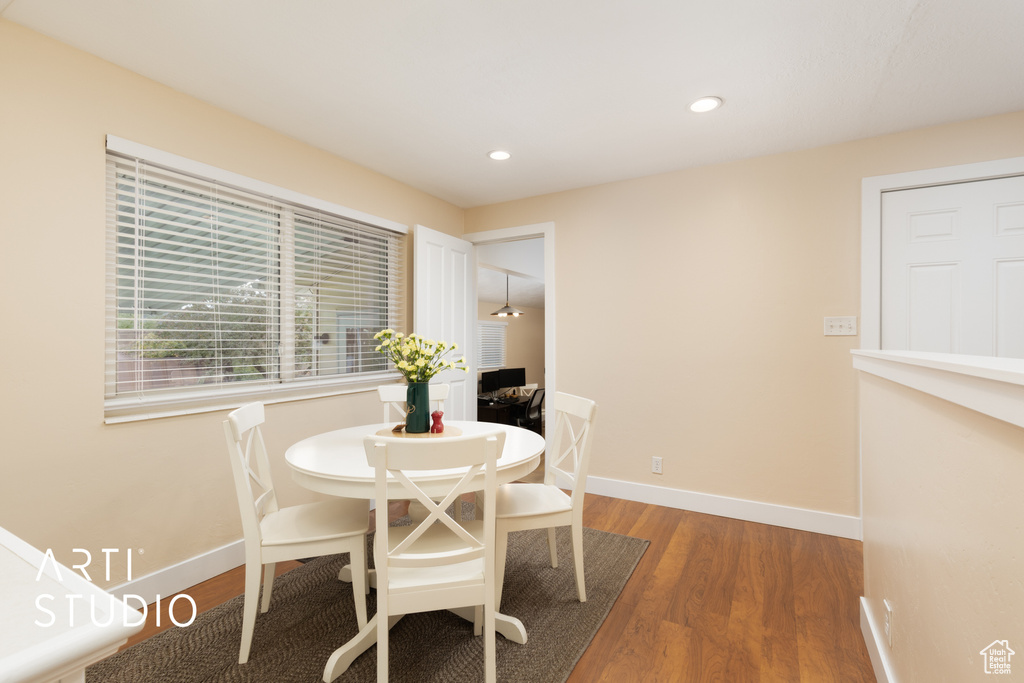 Dining area with wood finished floors, baseboards, and recessed lighting
