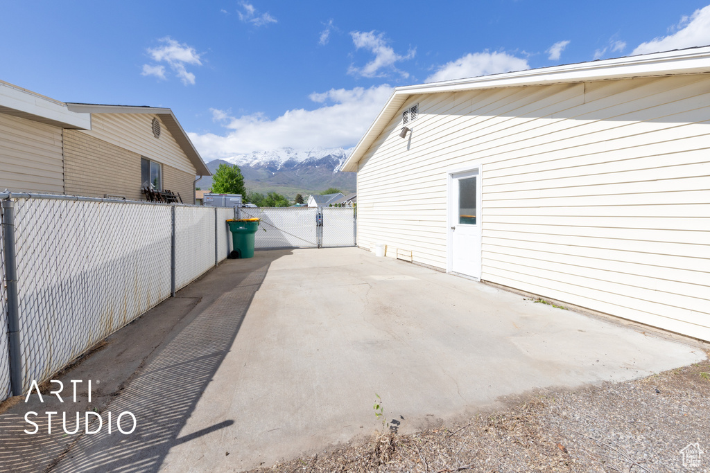 View of property exterior with a mountain view and a patio area