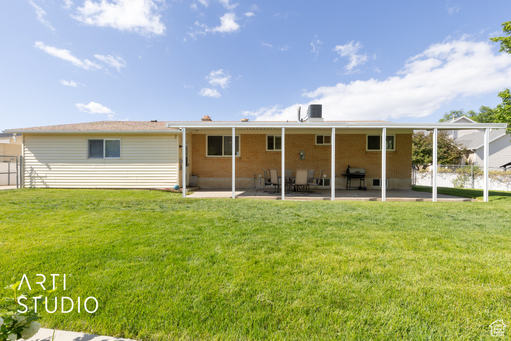 Back of house with brick siding and a patio area
