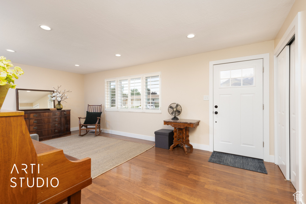 Entrance foyer with wood finished floors, recessed lighting, and baseboards