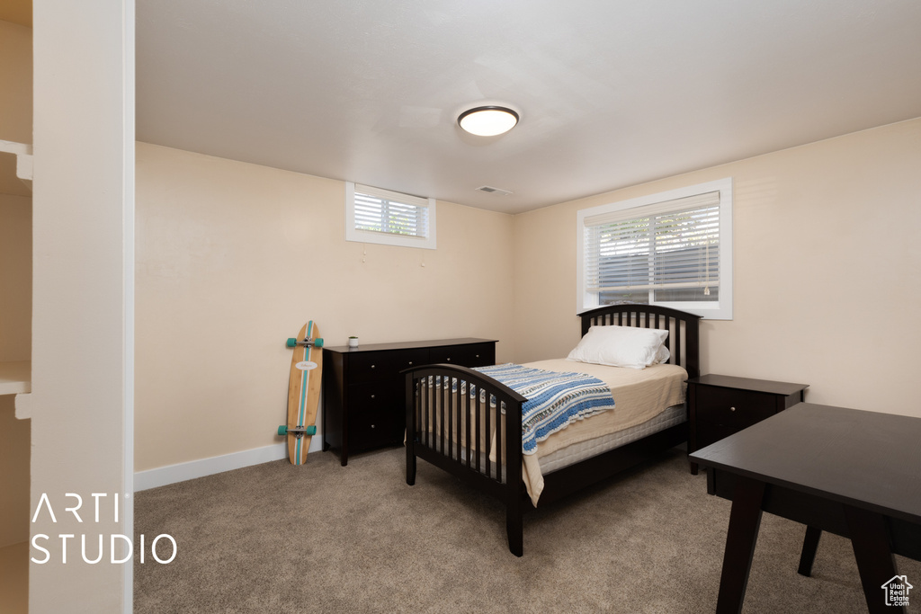 Carpeted bedroom featuring baseboards
