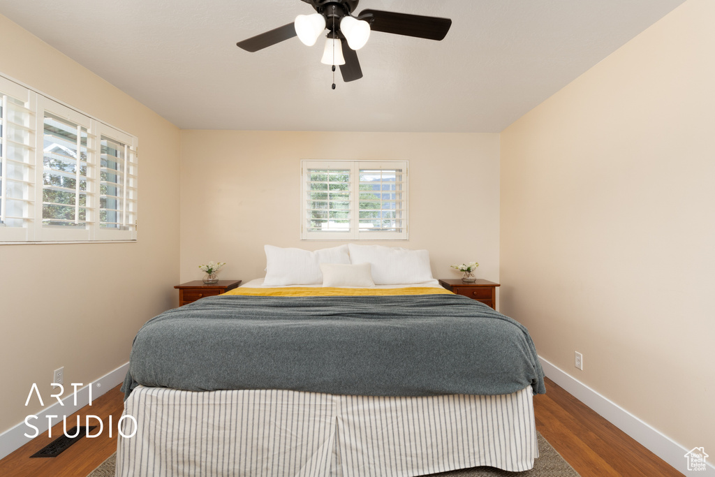 Bedroom featuring wood finished floors, baseboards, and ceiling fan