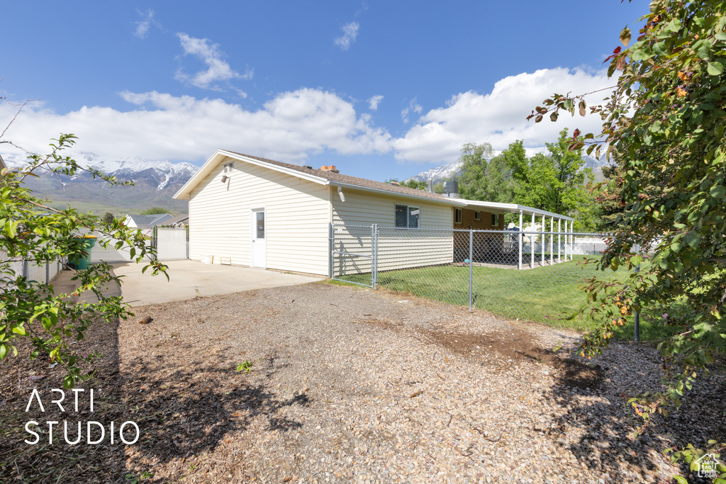 View of home\\\'s exterior with a patio, a mountain view, and driveway