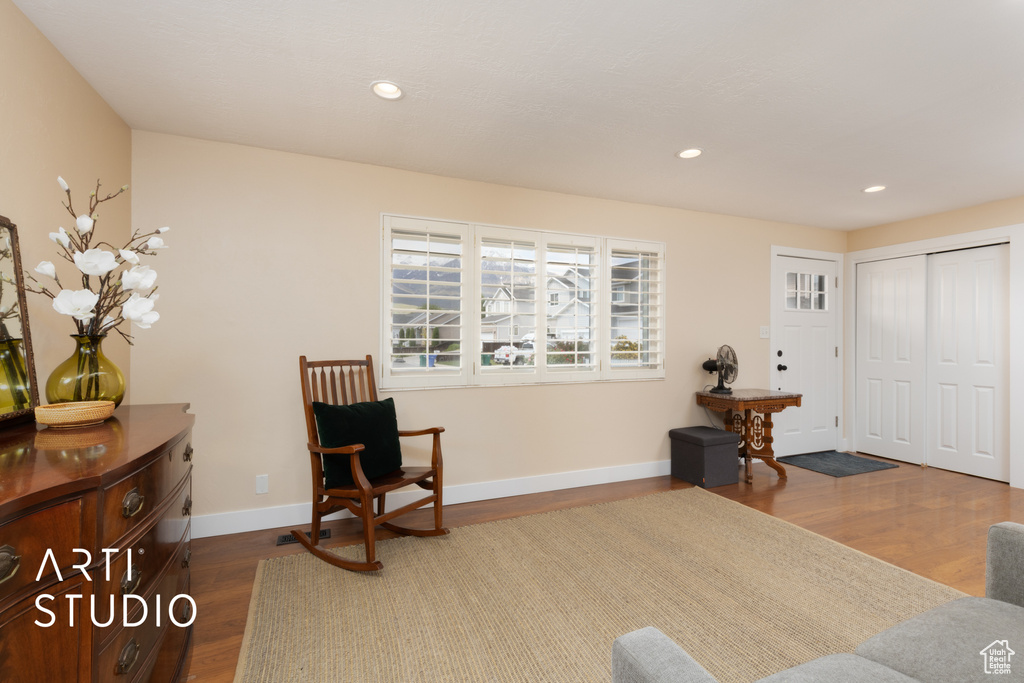 Sitting room featuring dark wood-style floors, recessed lighting, and baseboards