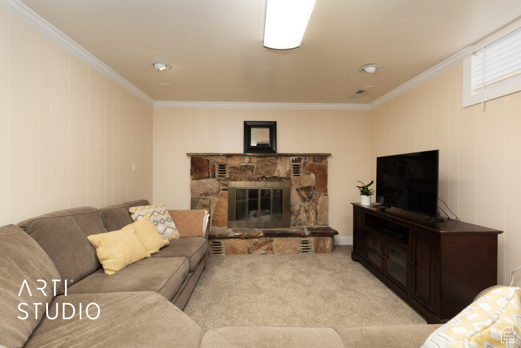 Living area with crown molding, light colored carpet, and a fireplace
