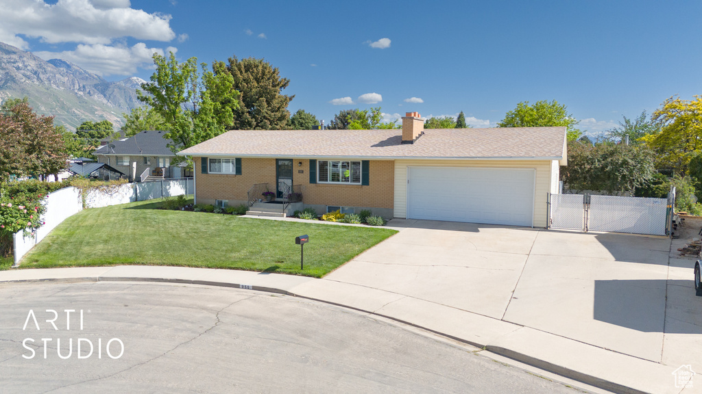 Ranch-style home with a gate, concrete driveway, a garage, a chimney, and brick siding
