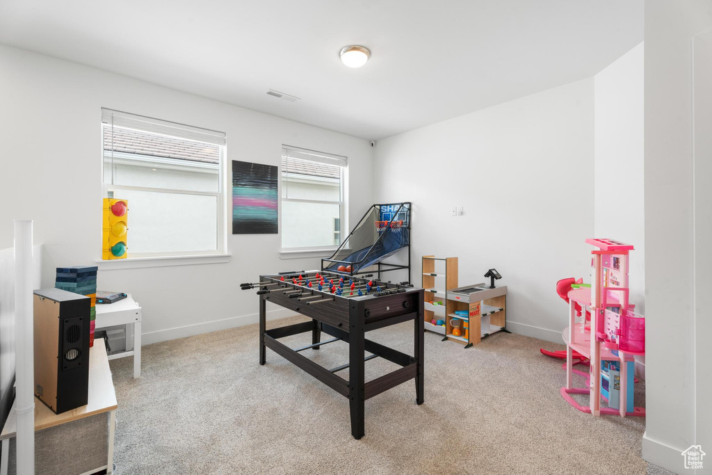 Rec room with carpet and baseboards