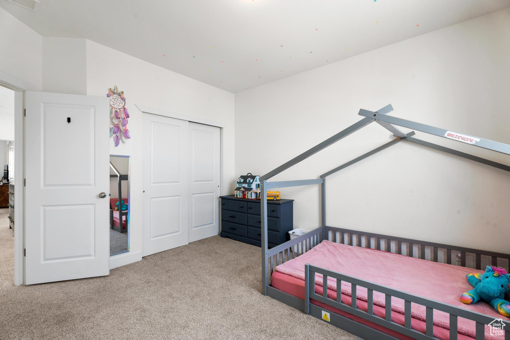 Bedroom with carpet and a closet