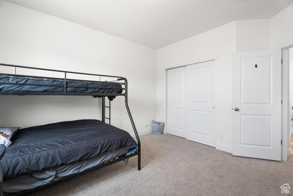 Bedroom featuring carpet flooring and baseboards