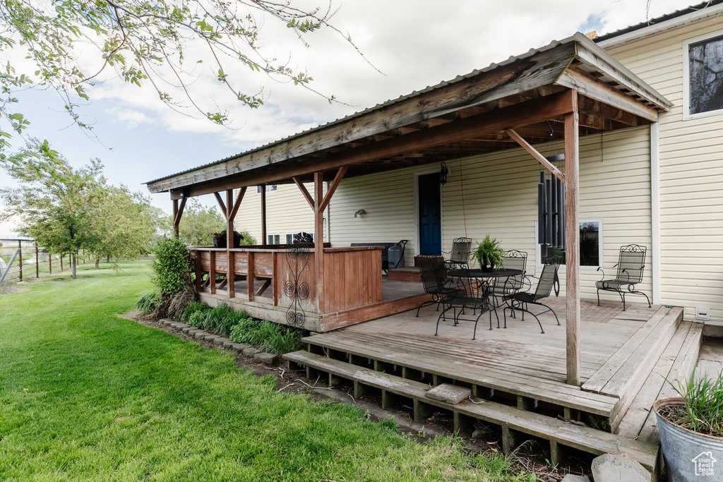 Wooden deck with a lawn and outdoor dining space