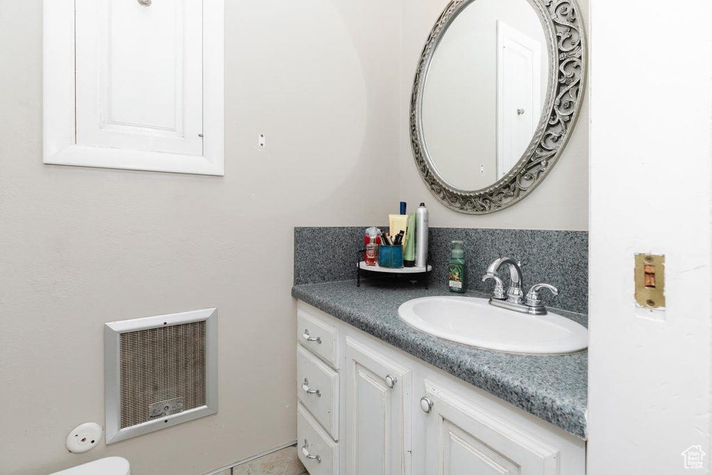 Bathroom with vanity and tasteful backsplash