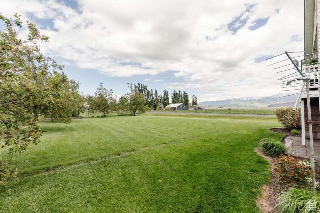 View of grassy yard with a mountain view