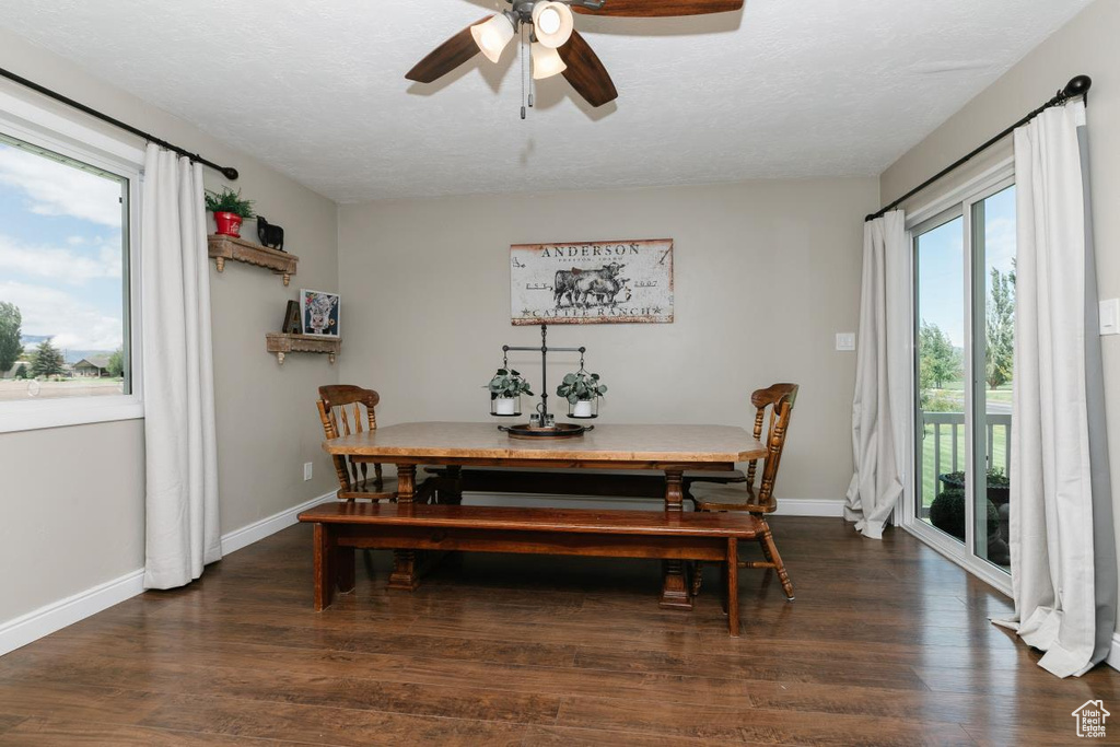 Dining room with ceiling fan, wood finished floors, and baseboards