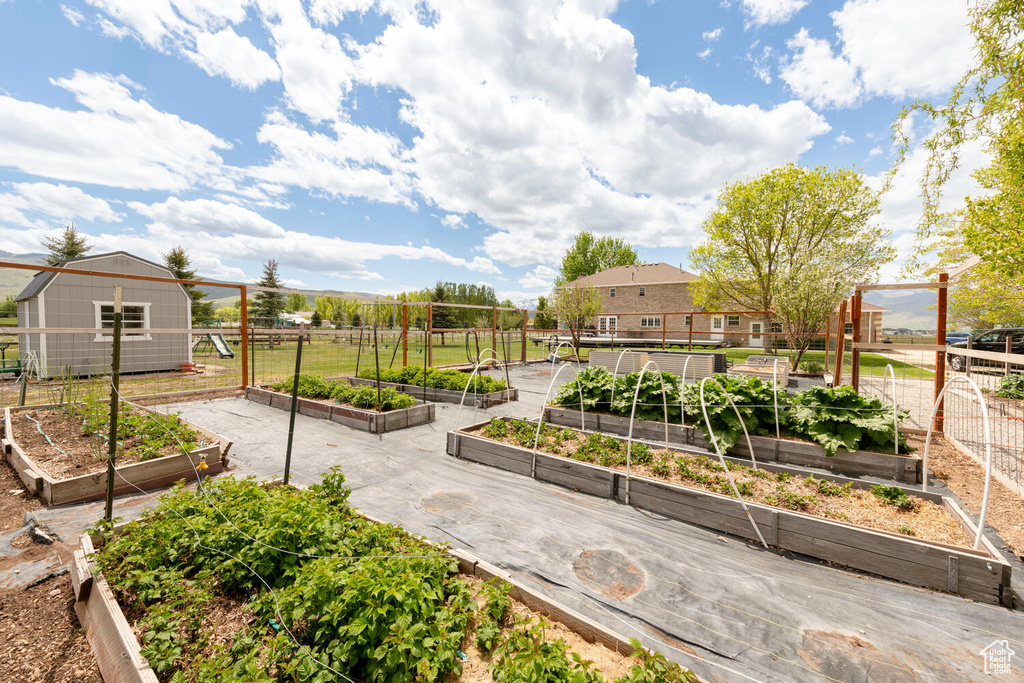 View of community with a garden and an outbuilding