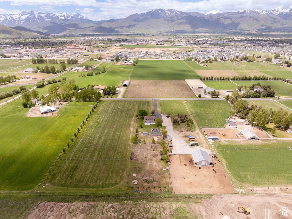 Aerial overview of property\'s location with a mountain backdrop and rural landscape