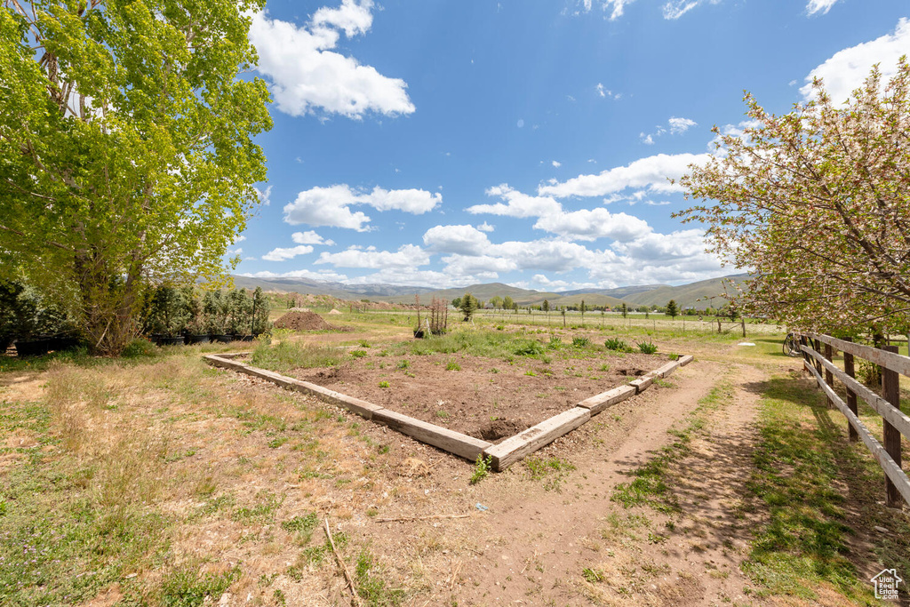 View of yard featuring a rural view and a mountain view