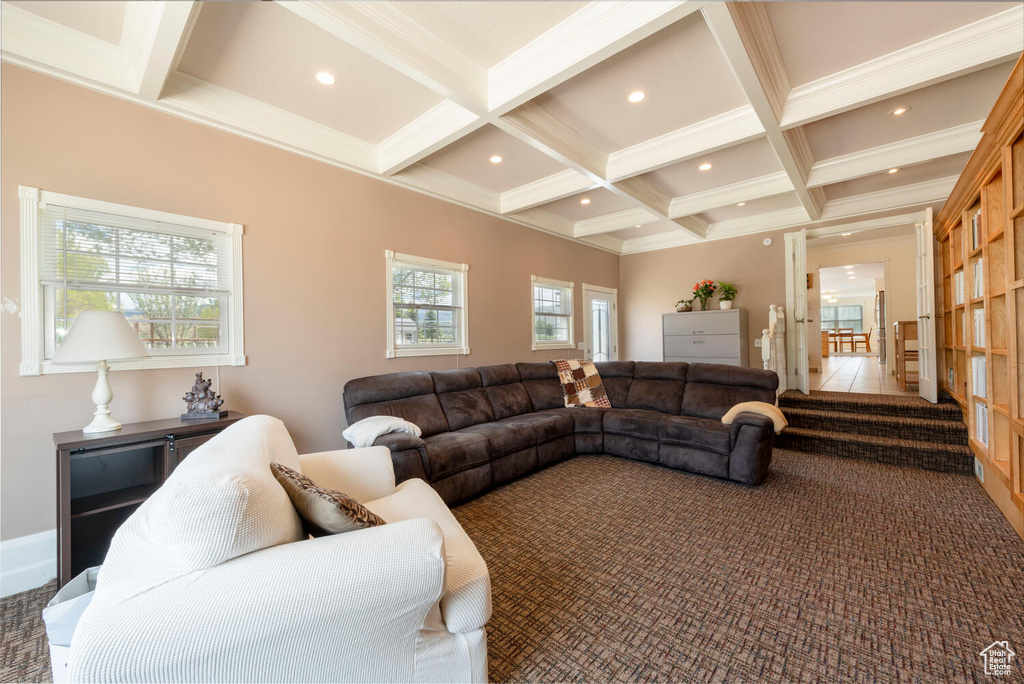Living area with coffered ceiling, beam ceiling, carpet, recessed lighting, and crown molding