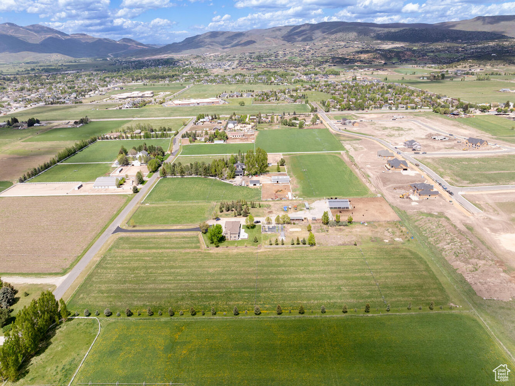 Aerial view of property\'s location with rural landscape and a mountainous background
