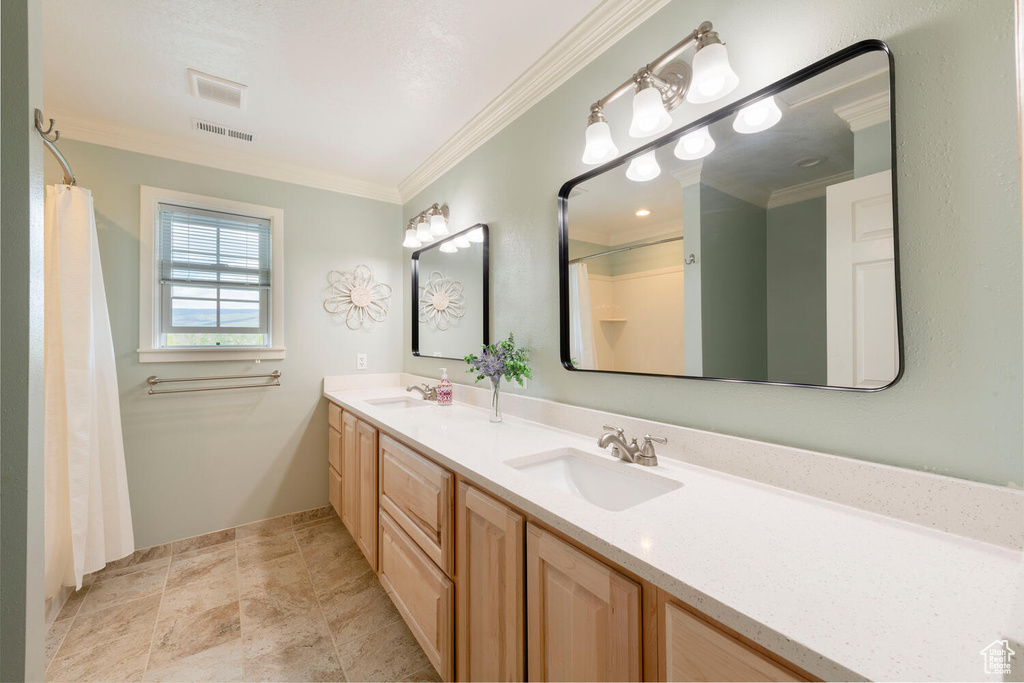 Full bath with crown molding, double vanity, and a shower with shower curtain