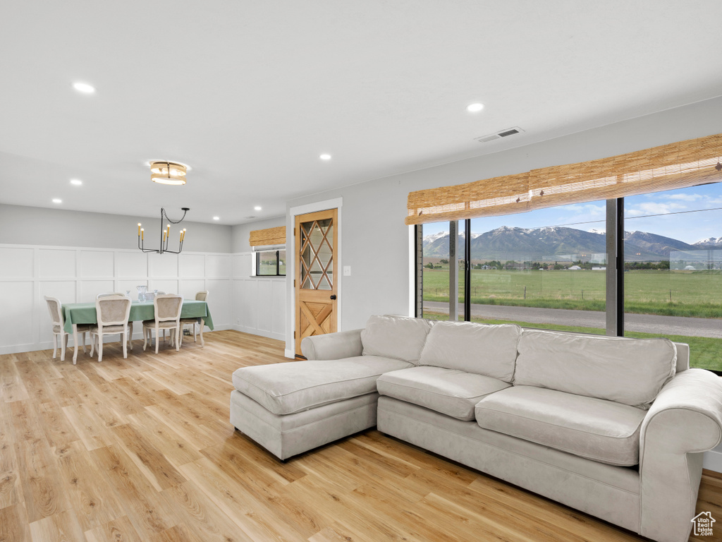 Living area featuring a mountain view, a chandelier, light wood-style floors, and recessed lighting