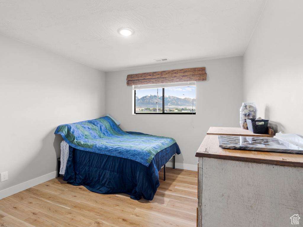 Bedroom featuring wood finished floors and baseboards