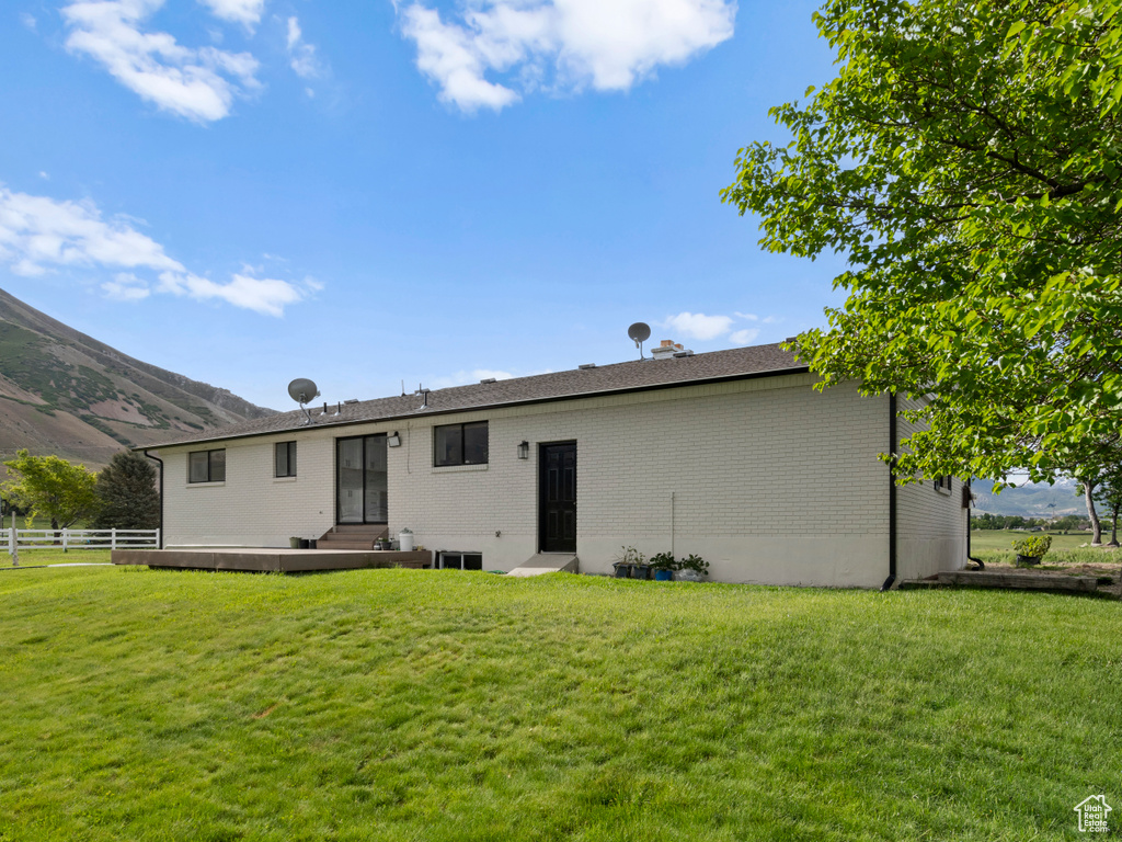 Back of property with brick siding, entry steps, and a mountain view