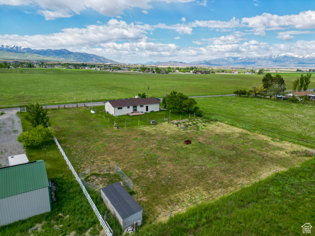 Overview of rural landscape featuring a mountainous background and agricultural land
