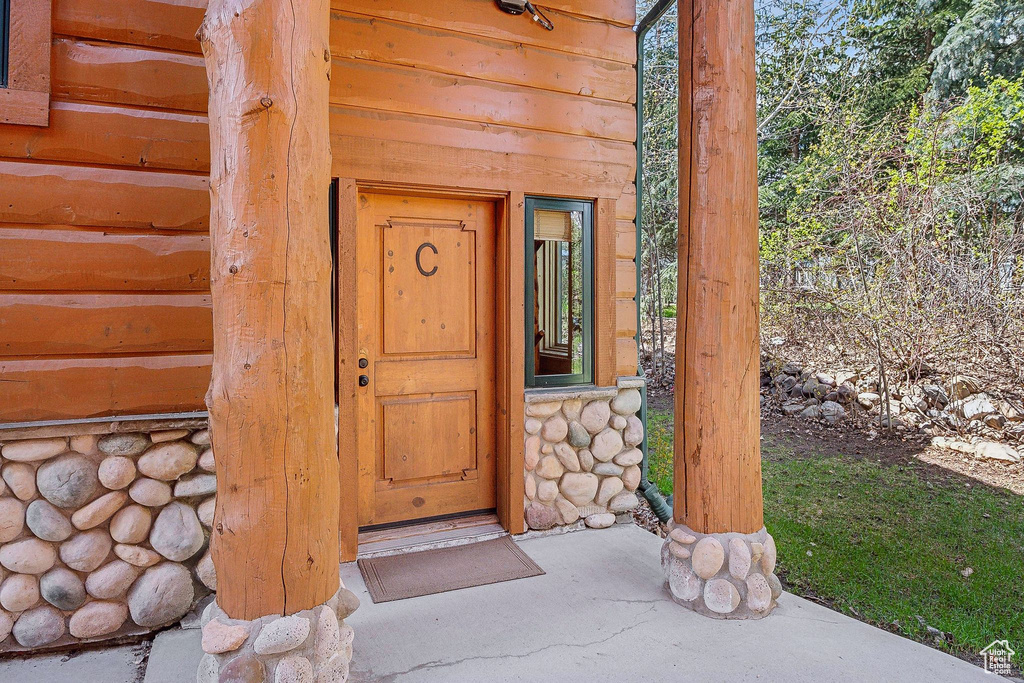 Entrance to property featuring faux log siding