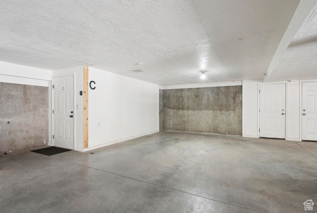 Garage featuring baseboards