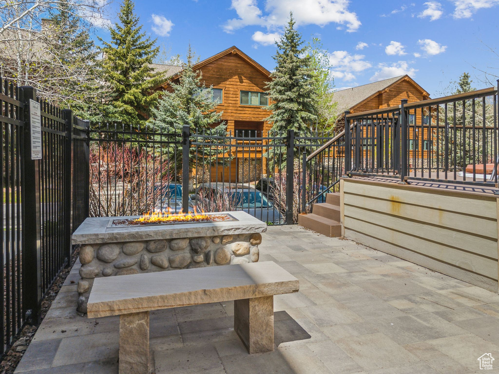 View of patio with a fire pit