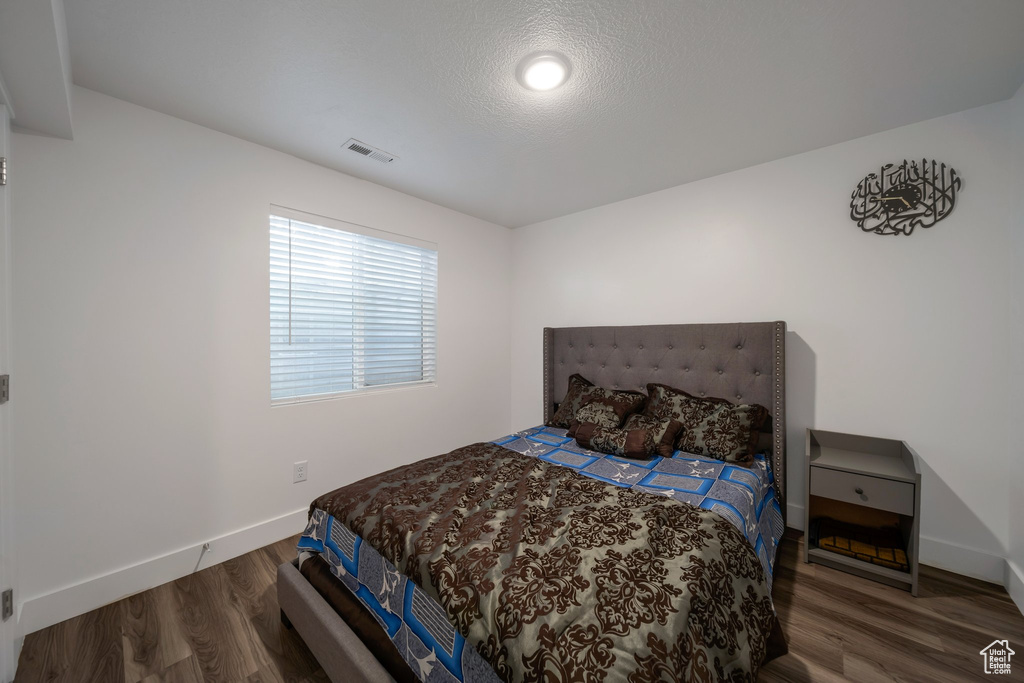 Bedroom featuring wood finished floors and baseboards