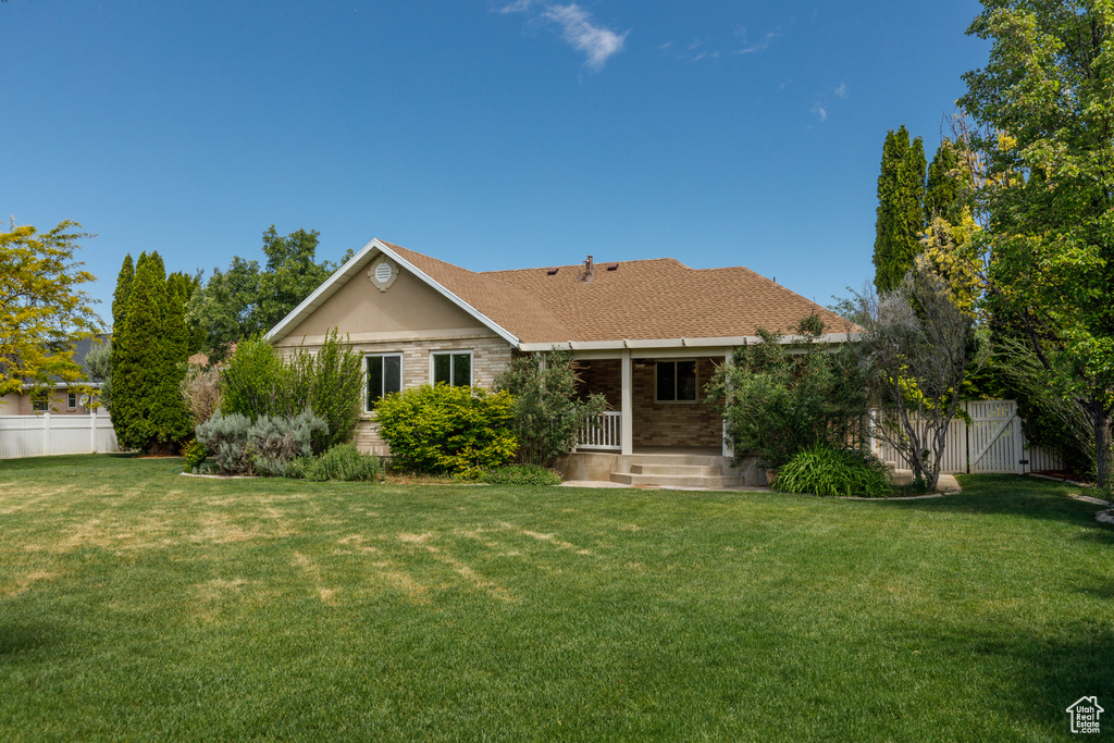 Rear view of property featuring a porch and brick siding