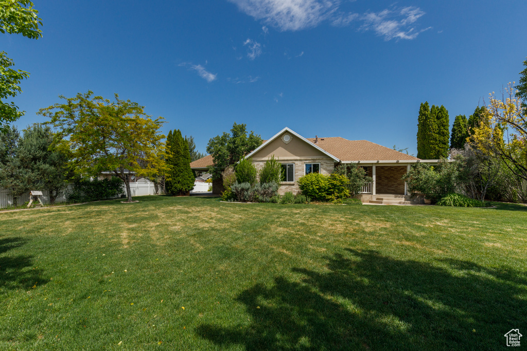 Rear view of property featuring a lawn