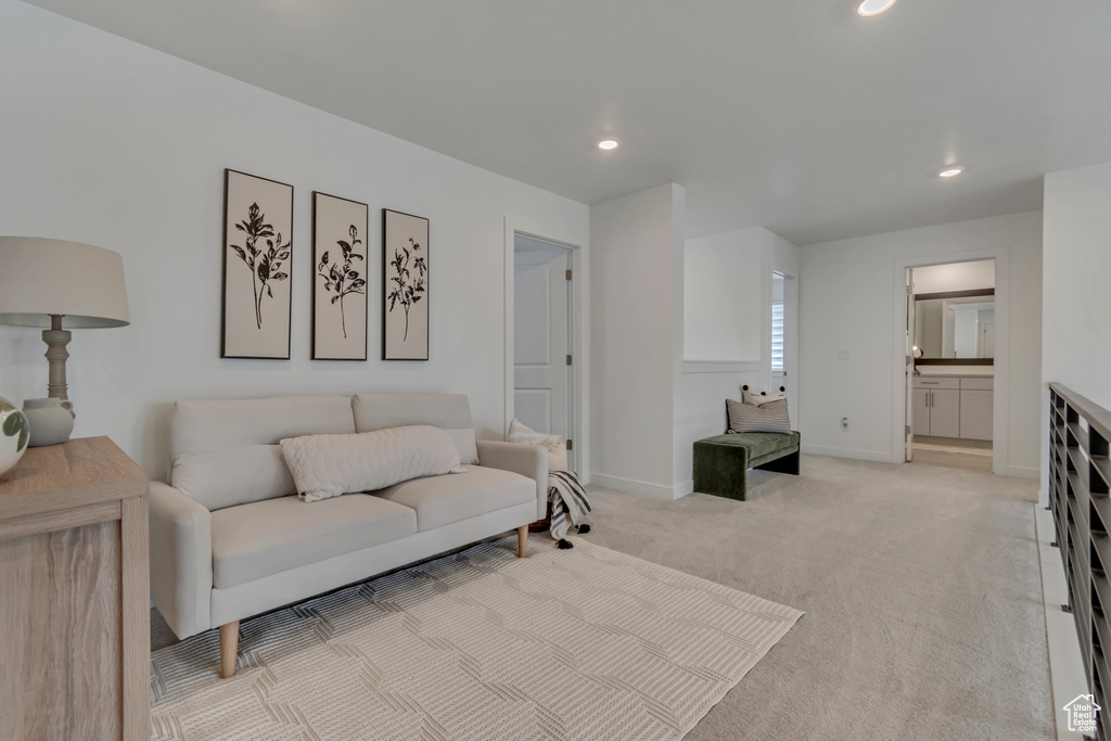 Living area featuring light carpet, recessed lighting, and baseboards