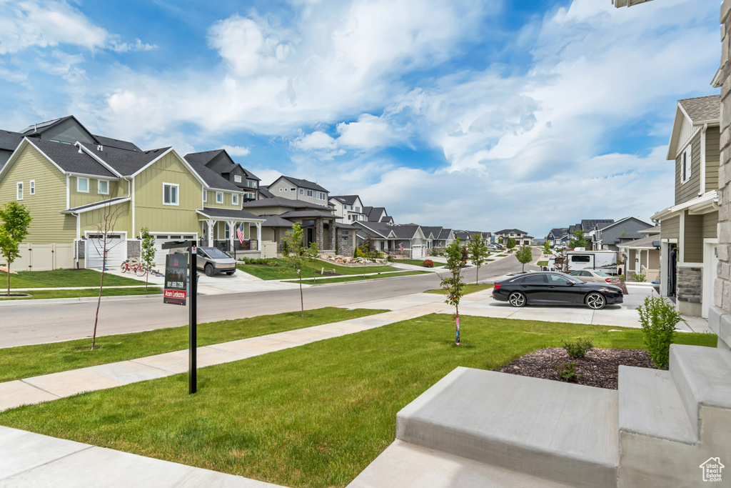 View of green lawn featuring a residential view