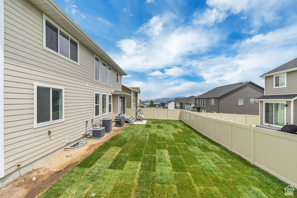 View of yard featuring a residential view and central air condition unit
